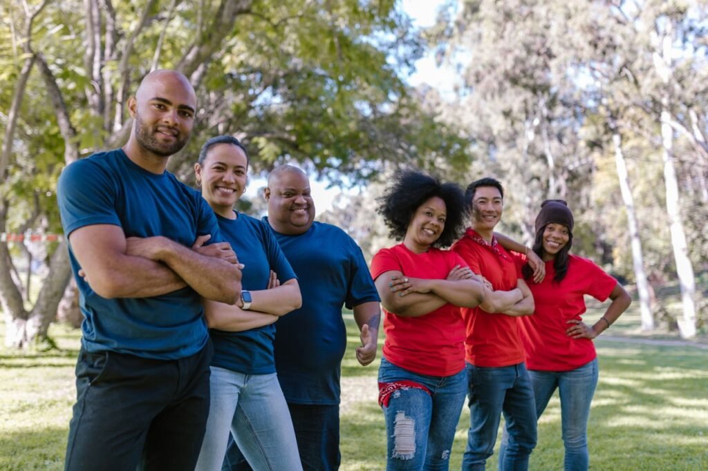 Diverse group of adults bonding and enjoying team activity in a park.